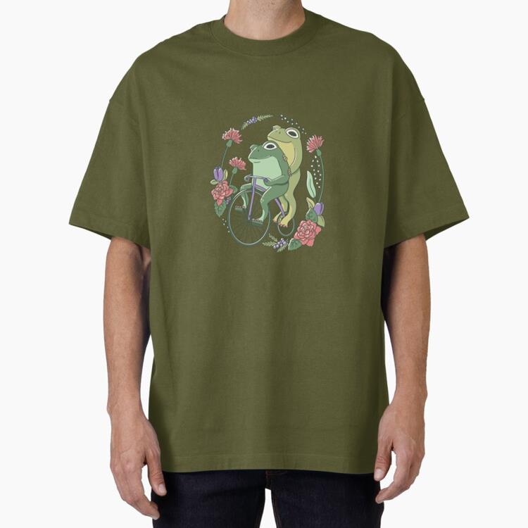 Two Frogs Riding A Bicycle Surrounded By Flowers Oversized T-Shirt